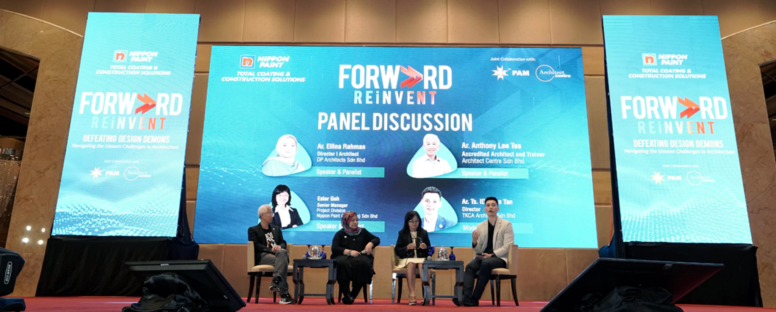 Panel discussion at the Nippon Paint "Forward Reinvent" event, featuring industry experts discussing architectural challenges. Speakers include Ar. Ellina Rahman, Ester Goh from Nippon Paint, Ar. Anthony Lee Tee, and Ar. Ts. Iqbal Tan. The event focuses on innovative solutions in design and construction.