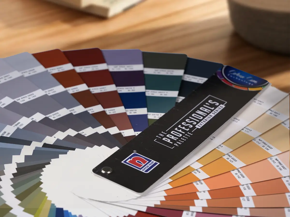 Nippon Paint color palette featuring a variety of shades arranged in a fan format, showcasing options for interior and exterior design projects. The palette includes the "Professional's Palette" branding, highlighting innovative color selections for professionals.