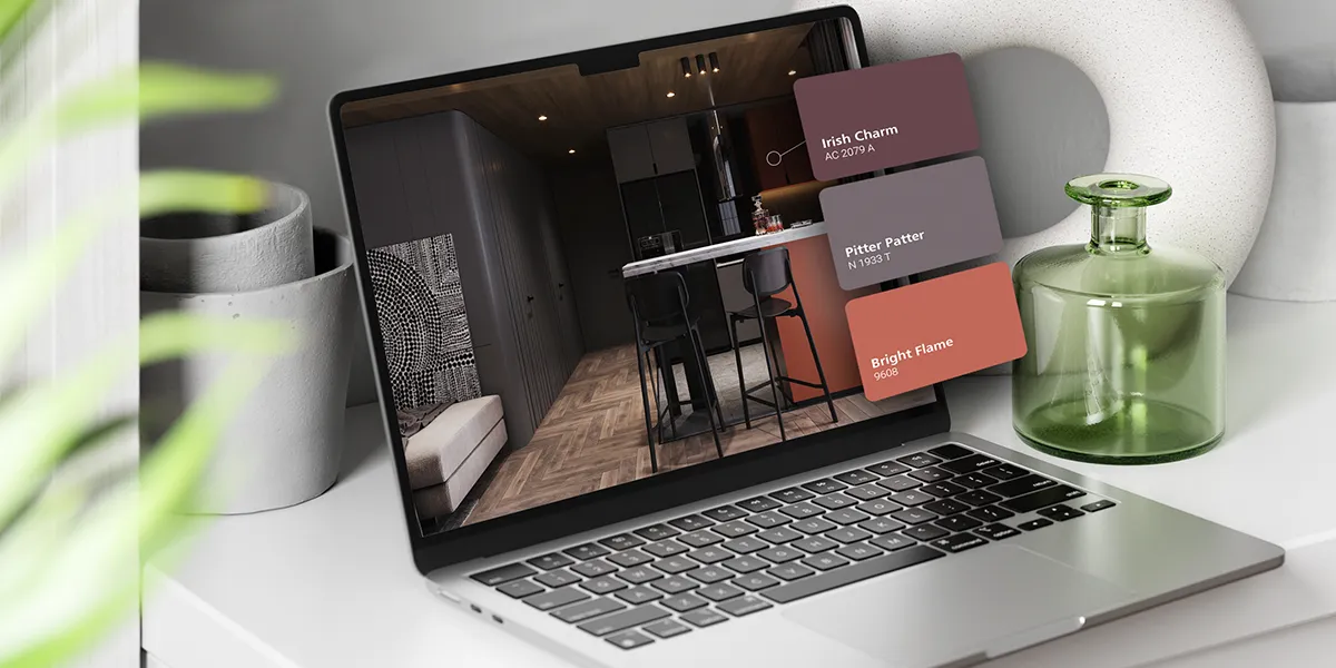 Interior design concept displayed on a laptop featuring Nippon Paint color swatches: Irish Charm, Pitter Patter, and Bright Flame, set against a modern kitchen backdrop with sleek cabinetry and stylish decor.