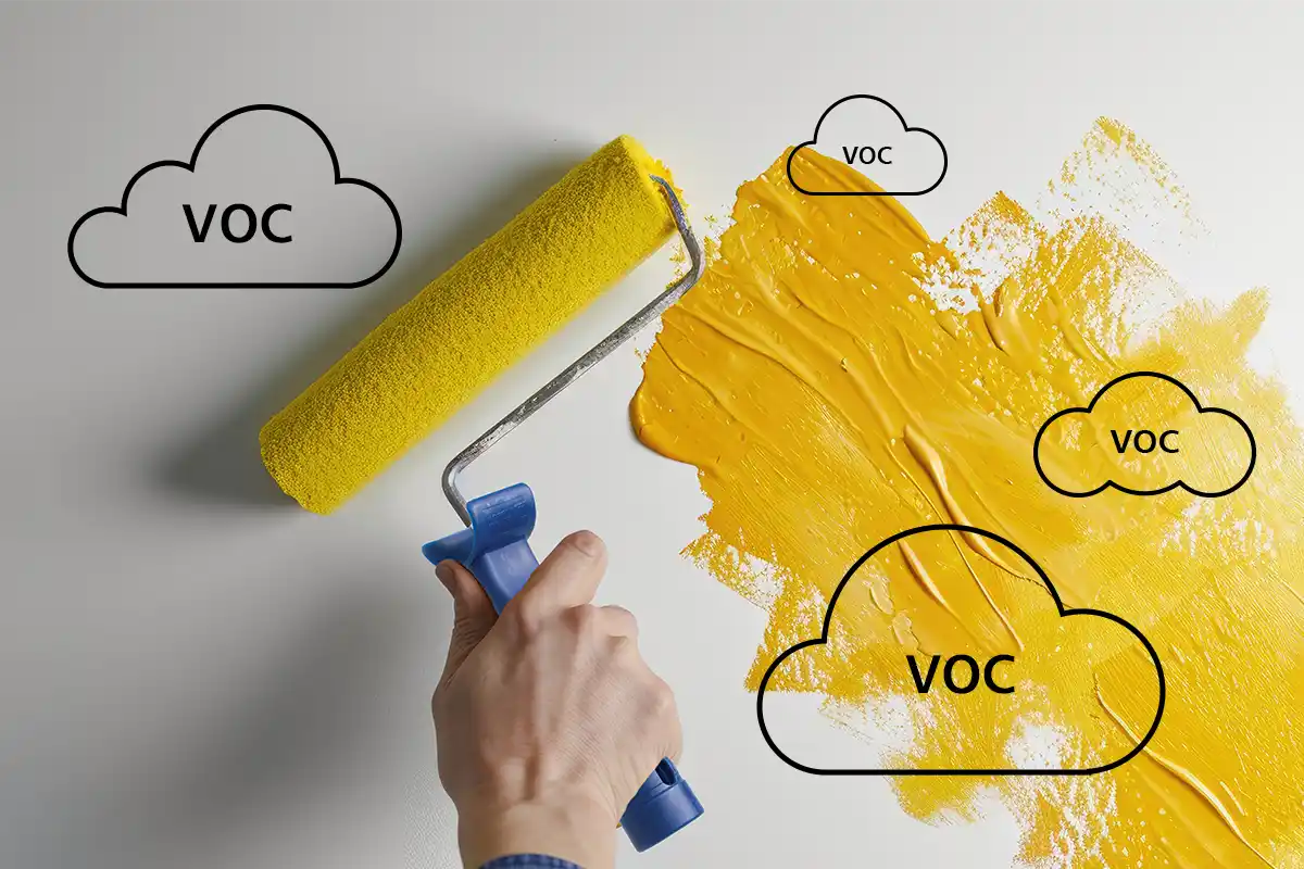Yellow paint being applied with a roller on a wall, illustrating VOC emissions. Nippon Paint products offer low-VOC options for a healthier indoor environment.