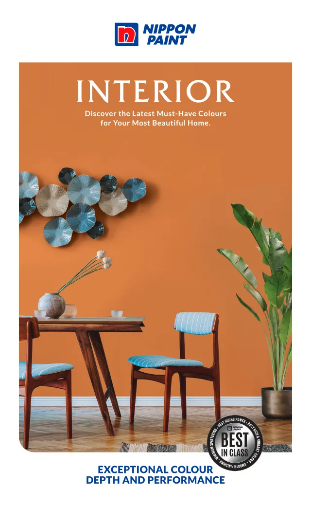 Interior design showcasing a stylish dining area with Nippon Paint's vibrant orange wall, complemented by modern furniture and decorative elements. The image highlights the latest color trends for creating a beautiful home, emphasizing Nippon Paint's exceptional color depth and performance.