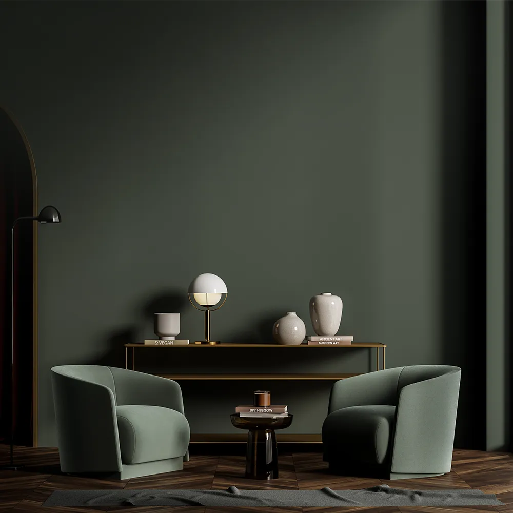 Stylish interior featuring two modern green armchairs, a sleek black side table, and decorative vases against a dark green wall, showcasing Nippon Paint's elegant color palette for contemporary living spaces.