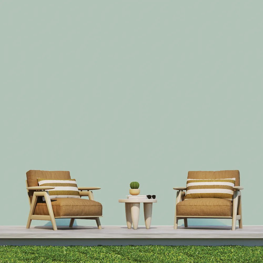 Cozy outdoor seating area featuring two stylish brown armchairs with striped cushions, a minimalist white side table, and a small potted cactus, all set against a calming mint green wall painted with Nippon Paint for a fresh look.