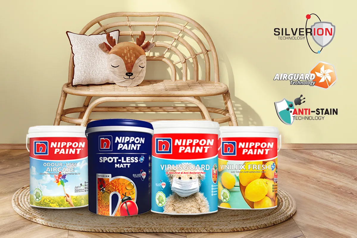 Nippon Paint products displayed in a cozy living space featuring a rattan bench and a decorative pillow. The image showcases Odour-less Aircare, Spot-Less Matt, VirusGuard, and Vinlex Fresh, highlighting advanced technologies like SilverIon, AirGuard, and Anti-Stain for enhanced indoor air quality and protection.